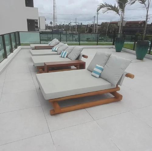 a row of chaise lounges on a roof at Muro alto - porto de galinhas -Makia beach in Ipojuca