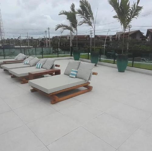 a row of chaise lounges sitting on a patio at Muro alto - porto de galinhas -Makia beach in Ipojuca
