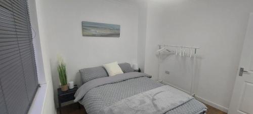 a small bedroom with a bed and a chair at Immaculate 3-Bed House in Hull in Hull