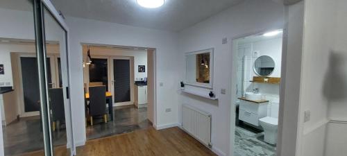 a white bathroom with a toilet and a mirror at Immaculate 3-Bed House in Hull in Hull