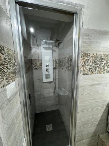 a walk in shower with a glass door in a bathroom at Civico 8 in Sassari