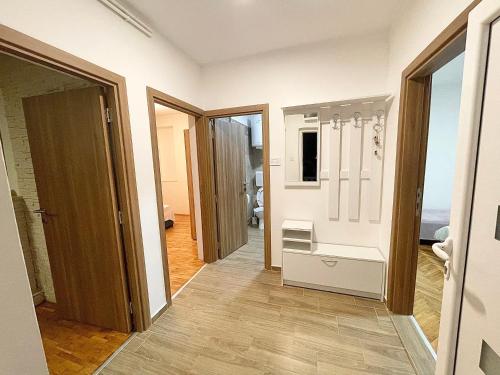 a corridor of a room with a door and a room with a floor at Bali Apartment in Belgrade