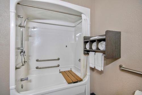 a small bathroom with a shower with a shower at Motel 6-Harlingen, TX in Harlingen