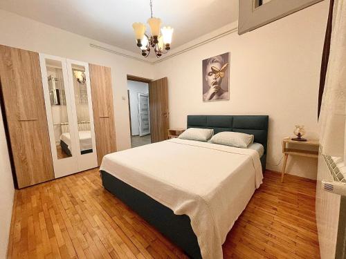 a bedroom with a large bed in a room at Bali Apartment in Belgrade