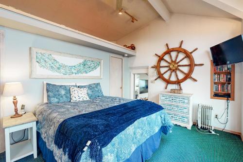 a bedroom with a bed and a steering wheel on the wall at Wave Watch `N in Oceanside