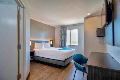 a hotel room with a bed and a window at Motel 6-Harlingen, TX in Harlingen