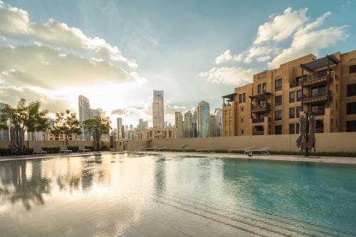 a swimming pool with a city in the background at Prime Retreats @ Burj Royale By Emaar in Dubai