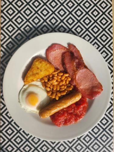 a plate of breakfast food with eggs bacon beans and corn at The Arabella in Blackpool