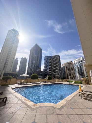 a swimming pool with a city skyline in the background at GMA Amwaj 2BR Sea View High Floor in Dubai