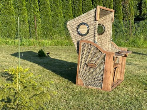 a large wooden structure sitting in the grass at Wellness-Beskydy in Prostřední Bečva