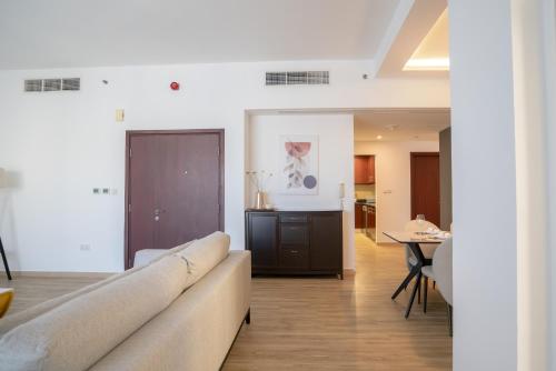 a living room with a couch and a table at GMA Amwaj 2BR Sea View High Floor in Dubai