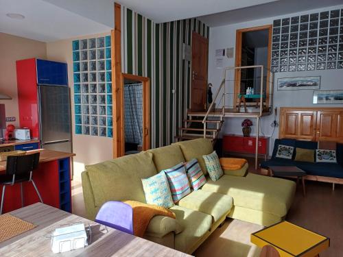 a living room with a couch and a table at Apartamento Puerta del Pirineo in Sabiñánigo
