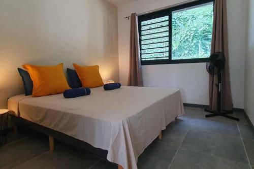 a bed in a room with a large window at Le Fare APE TARUA in Taputapuapea