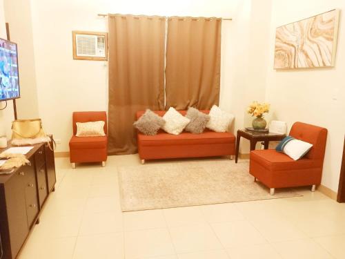 a living room with a couch and two chairs at Unit 3J Signature Suites, Lafayette Megaworld in Iloilo City