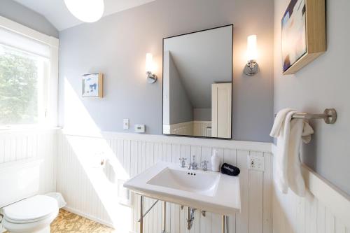 a white bathroom with a sink and a mirror at 1830's Large 4BR in Heart of Acadia! [Somes Villa] in Somesville