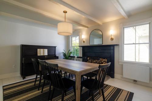 a dining room with a wooden table and chairs at 1830's Large 4BR in Heart of Acadia! [Somes Villa] in Somesville