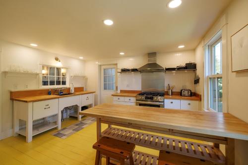 a large kitchen with a wooden table in it at 1830's Large 4BR in Heart of Acadia! [Somes Villa] in Somesville