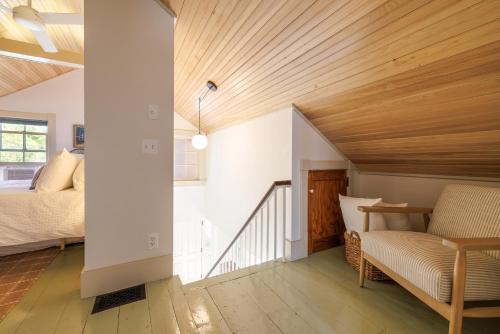 a room with a bed and a couch and wooden ceilings at 1830's Large 4BR in Heart of Acadia! [Somes Villa] in Somesville