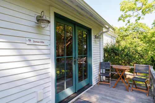 a front door of a house with a table and chairs at 1830's Large 4BR in Heart of Acadia! [Somes Villa] in Somesville