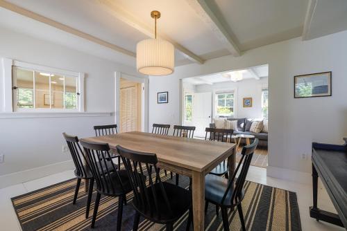 a dining room with a wooden table and chairs at 1830's Large 4BR in Heart of Acadia! [Somes Villa] in Somesville