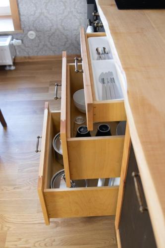 a kitchen with a wooden cabinet with drawers at Charming Rustic Retreat in Lahemaa National Park in Kolga