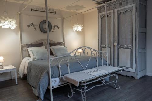 a bedroom with a canopy bed and a table at Givernel in Giverny