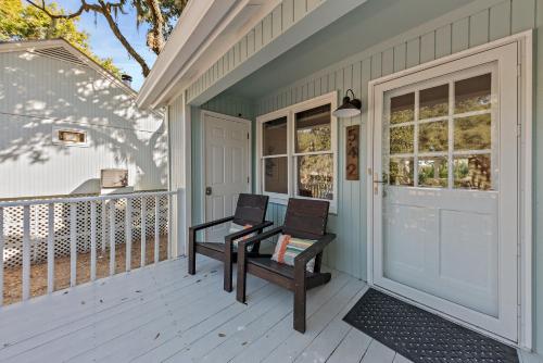 a pair of chairs sitting on a porch at 542 Tarpon Pond Cottage in Seabrook Island