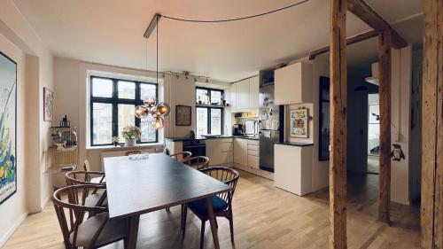 una cucina e una sala da pranzo con tavolo e sedie di ApartmentInCopenhagen Apartment 1583 a Copenaghen