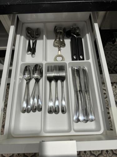 a drawer filled with silver utensils in a cabinet at Contractors, Groups 4BR 5xDB Close to City free parking sleeps x 10 in Leeds