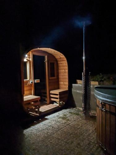 a dark room with a bath tub and a window at Chalupa Nonnetit in Vápenice