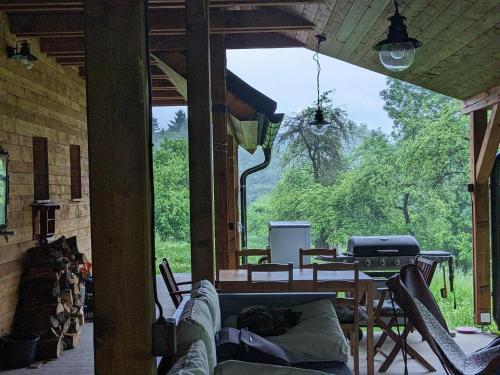 a screened in porch with a couch and a grill at Chalupa Nonnetit in Vápenice