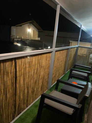 a couple of chairs sitting on a balcony at night at La casa di Cate & Adry in Envie