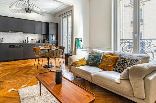 a living room with a couch and a table at T2 Haussmannien renovated in Paris - Welkeys in Paris