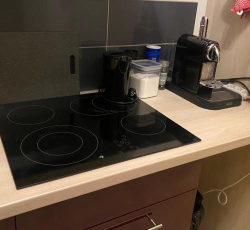 a black stove top on a counter in a kitchen at Appart lux in Luxembourg