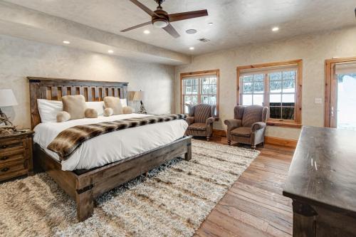 a bedroom with a large bed and two chairs at Pine Mountain Sanctuary in Edwards