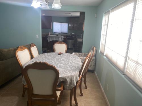 a dining room with a table and chairs and a kitchen at 5821 Gowdy lane bakersfield Ca 93307 in Bakersfield
