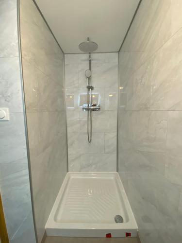 Un baño con ducha con puerta de cristal. en Bienvenue chez Jules *Verne*, en Amiens