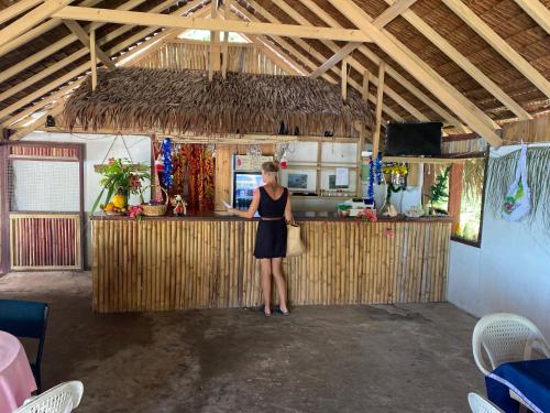 a woman standing at a bar in a kitchen at Million Dollar View in Luganville