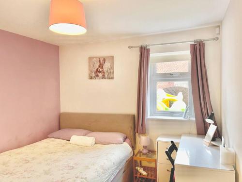 a small bedroom with a bed and a window at Entire Flat Free Parking Quiet Area *Self-Check In in Headingley