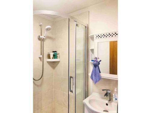 a bathroom with a shower and a sink at Entire Flat Free Parking Quiet Area *Self-Check In in Headingley