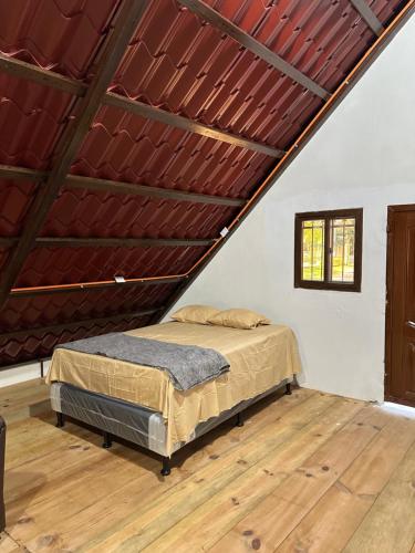 a bedroom with a bed in a attic at CABAÑA RIO ATULAPA #1 in Esquipulas