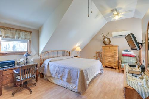 a bedroom with a bed and a desk and a television at Quiet Bradford Retreat Near Hiking and Fishing! 