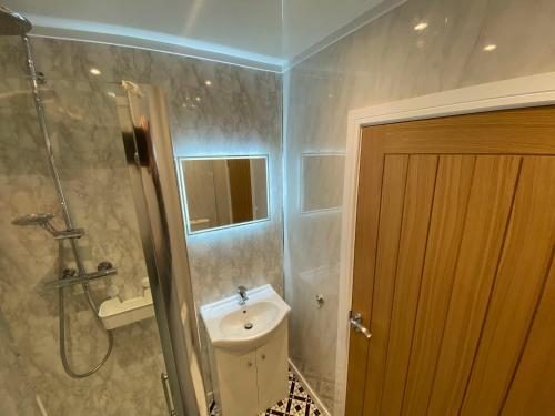 a bathroom with a shower and a toilet and a sink at Wellbank View - Brand New in Washington
