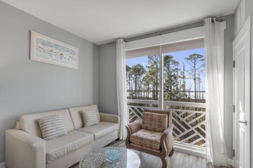 a living room with a couch and a large window at Sandestin Resort Bahia-Elation by Tufan in Destin