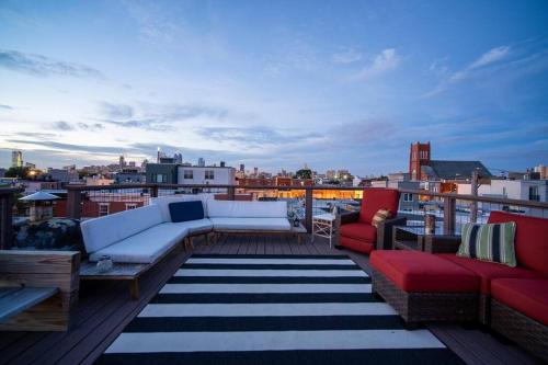 a balcony with couches and a view of a city at Double Decker Roofdeck Gorgeous View in Passyunk in Philadelphia
