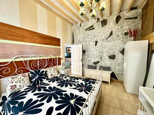 a bedroom with a black and white bed and a wall at Casa Estrada Coastal Haven in Caleta de Interián