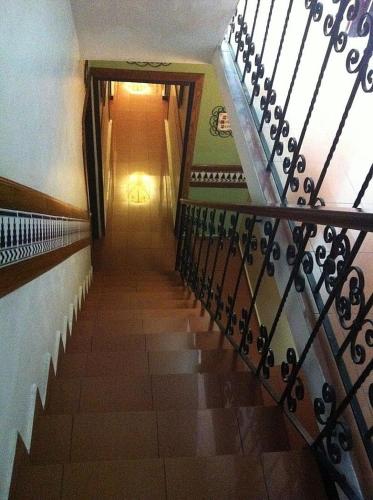 a hallway with a staircase with a stair railing at Hotel Iberia - San Juan in San Juan