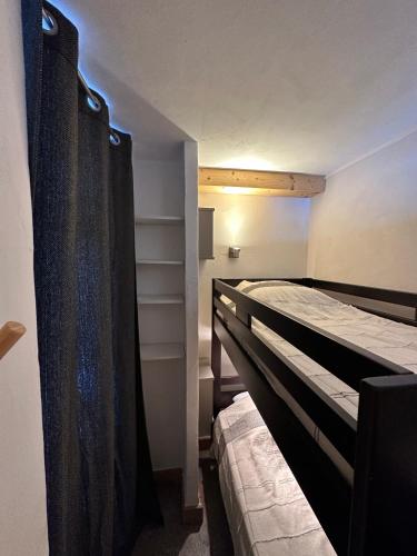 une chambre avec deux lits superposés dans une pièce dans l'établissement Paquebot des Neiges - Appartement 4 personnes - Vue Mont Blanc, à Aime La Plagne