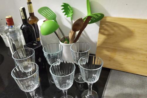 a group of wine glasses on a table with wine bottles at Apartamento en el corazón de la Medina in Tetouan