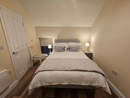 a bedroom with a large bed with two pillows at Private House in Oldcastle in Oldcastle